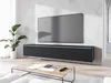A modern living room scene featuring a wall-mounted TV bank and a coffee table. Náhled obrázku produktu