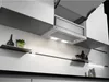 A modern kitchen with a built-in range hood and shelves. Voir les images du produit