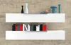 Two white shelves mounted on a concrete wall, displaying decorative objects and books. Podgląd zdjęcia produktu