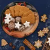 A collection of Christmas cookies and decorations arranged on a dark blue surface. Produktbild-Vorschau