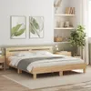 A bedroom scene with a wooden bed frame, bedding, and decorative elements. Voir les images du produit
