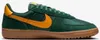 A side view of a green and yellow Nike sneaker with a brown sole. Podgląd zdjęcia produktu