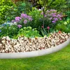 A garden bed with a metal border and various flowers and plants. Voir les images du produit