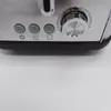 A close-up view of the control panel of a toaster, showing buttons and a dial. Produktbild-Vorschau