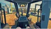 View from inside a construction vehicle cab, looking out at a construction site. Náhľad obrázku produktu