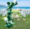 A wedding setup on a beach with a balloon arch, floral stands, and chairs. Náhled obrázku produktu
