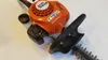 A close-up, top-down view of a Stihl hedge trimmer. Produktbild-Vorschau