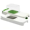 A white and green vegetable chopper with a clear plastic lid. Produktbild-Vorschau