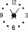 A close-up view of a black wall clock with numbers and hands on a white background. Náhled obrázku produktu