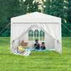 Two children are having a picnic inside a white party tent set up on a grassy lawn. Voir les images du produit