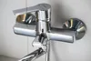 A close-up shot of a chrome bathroom faucet mounted on a tiled wall. Náhľad obrázku produktu