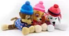 Three Paw Patrol plush toys dressed in winter attire, lying down. Produktbild-Vorschau