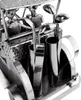A close-up view of a metal golf cart sculpture with golf clubs. Podgląd zdjęcia produktu