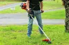 A person is using a string trimmer in a grassy area. Podgląd zdjęcia produktu