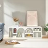 A modern living room with a white media console filled with decorative items and books, next to a blue sofa and a rug. Anteprima dell’immagine prodotto