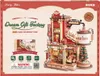 The image shows the packaging of a 3D wooden puzzle model of a "Dream Gift Factory" with Christmas-themed elements. Podgląd zdjęcia produktu