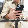 A person holding a smartphone while leaning on the handlebars of an electric scooter. Náhled obrázku produktu