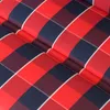 A close-up view of a red, blue, and white plaid fabric. Produktbild-Vorschau