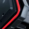 A close-up view of the edge of a black tool case with a red seal. Náhled obrázku produktu