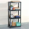 A black, four-tier plastic shelving unit is shown against a white brick wall and gray floor. Náhled obrázku produktu