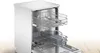 An open white dishwasher with its racks extended. Produktbild-Vorschau
