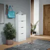 A hallway with a shoe cabinet, a plant, a bag, and a rug. Produktbild-Vorschau