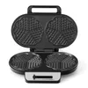 A black waffle maker with heart-shaped molds is shown open against a white background. Produktbild-Vorschau