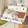 A white sofa bed with integrated storage and LED lighting, set up in a bedroom. Voir les images du produit