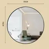 A round mirror with a black frame is shown against a light beige background. Dimensions are indicated by text. Produktbild-Vorschau