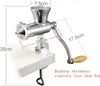 A manual meat grinder/juicer attached to a white tabletop, with measurement indicators. Produktbild-Vorschau
