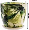 A ceramic pot with a green leaf pattern and a matching saucer, with dimensions indicated by text overlays. Voir les images du produit