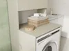 A laundry room with a washing machine and a cabinet. Náhľad obrázku produktu