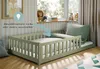 A child's bed with protective rails in a bedroom setting. Voir les images du produit