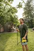 A man is spraying a tree in a garden with a Kärcher battery-powered pressure sprayer. Produktbild-Vorschau