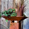 A decorative garden column with a planter filled with plants and a metal accent. Produktbild-Vorschau