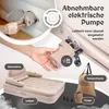 A hand is shown attaching a removable electric pump to an inflatable bed. The bed is set up with a headboard and armrests. Accessories like a storage bag and the pump itself are also visible. Produktbild-Vorschau