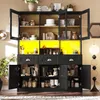 A large black kitchen cabinet with glass doors and yellow interior lighting, filled with various kitchenware and pantry items. Podgląd zdjęcia produktu
