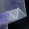 A close-up view of a folded sheer curtain with a purple firework pattern on a gray background. Produktbild-Vorschau
