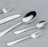A collection of silverware arranged on a plain gray background. Anteprima dell’immagine prodotto