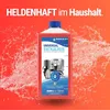 A bottle of universal descaler with images of household appliances on a red, watery background. Produktbild-Vorschau