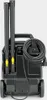 The back of a KÄRCHER SG 4/4 Dampfreiniger (steam cleaner) is shown against a light gray background. The steam cleaner has two long, dark gray tubes stored vertically on the back, with yellow accents at their base. A coiled black power cord with a plug is  Voir les images du produit
