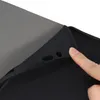A close-up shot of a black tablet case with a finger pressing on the edge. Podgląd zdjęcia produktu