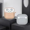 Two earbud cases are displayed on dark platforms against a light gray and white background. Produktbild-Vorschau