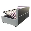 A bed frame with its mattress support raised, revealing storage space underneath. The headboard has integrated LED lighting. Náhled obrázku produktu