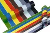 Several rolls of colored tape are arranged diagonally across a white background, with some rolls in the foreground and others in the background. Anteprima dell’immagine prodotto