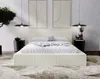 A modern bedroom with a beige upholstered bed as the focal point. Produktbild-Vorschau