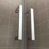 A close-up view of modern shower door handles against a tiled wall. Produktbild-Vorschau