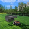 A robotic lawnmower is parked next to a protective garage structure on a green lawn, with trees and a modern building in the background. Anteprima dell’immagine prodotto