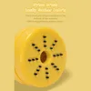 Close-up of the bottom of a yellow mini desktop vacuum cleaner, showing its nylon brushes. Produktbild-Vorschau