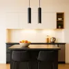 A modern kitchen island with two pendant lights hanging above it. Náhled obrázku produktu